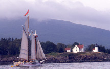 Windjammer sailing by Camden lighthouse