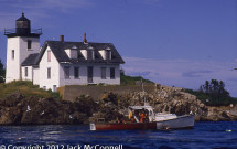 Lobster boat working in front of Indian Island Lighthouse
