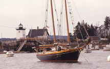 Sailboat in harbor w. Grindle Point Lighthouse